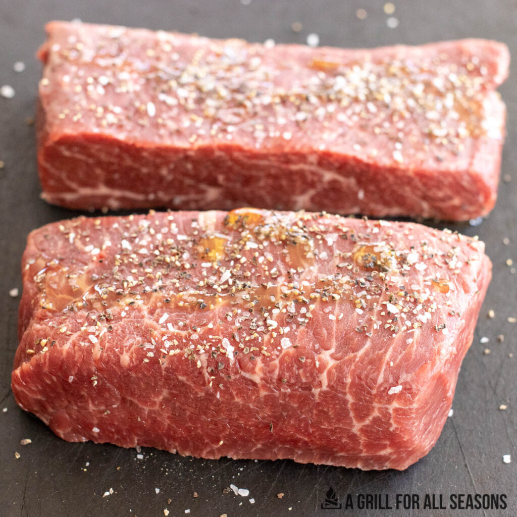 seasoned steaks on cutting board