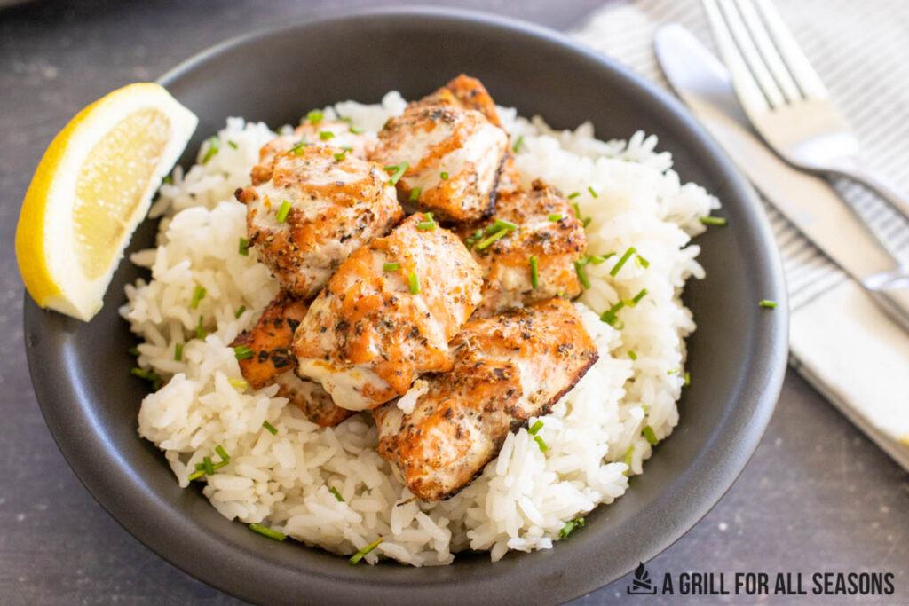 bowl with rice topped with grilled cajun salmon bites