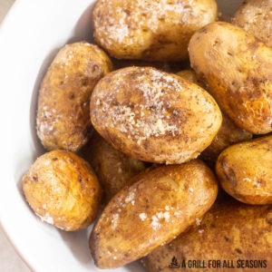 traeger baked potatoes in a large bowl showing salty crispy skin
