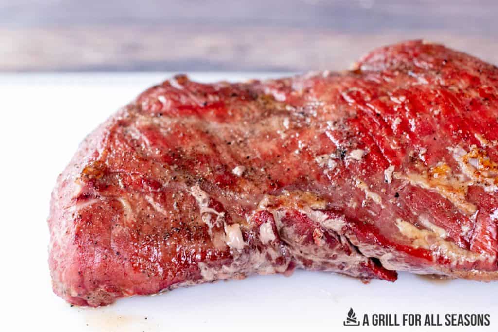 close up of steak resting on cutting board