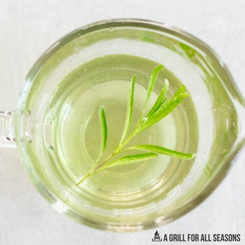 rosemary simple syrup recipe in small glass pitcher