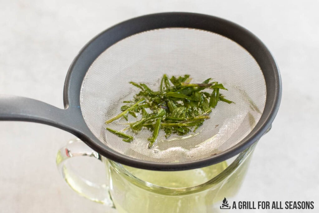 mesh strainer straining out the herb