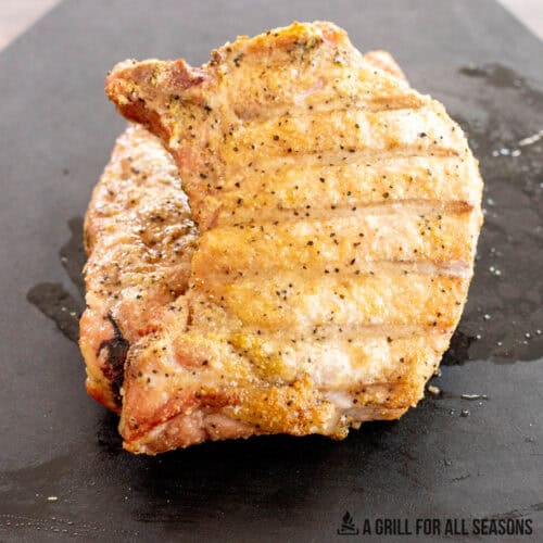 traeger pork chops resting on cutting board