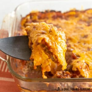 venison casserole recipe shown with a serving spoon lifting up a serving