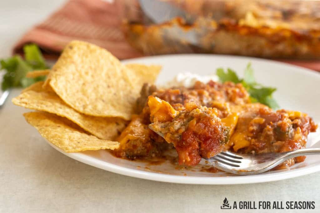 venison casserole recipe on plate with tortilla chips