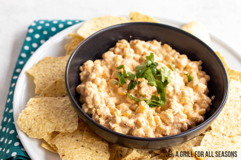 elote mexican corn dip in a black bowl