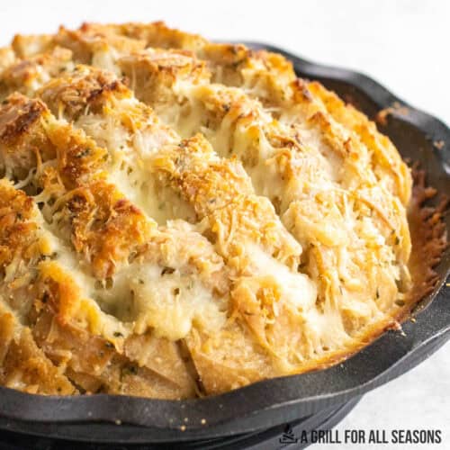 cheese stuffed garlic bread recipe close up in cast iron pie plate