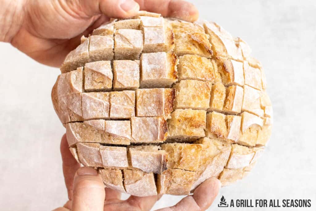 hands showing cuts in bread