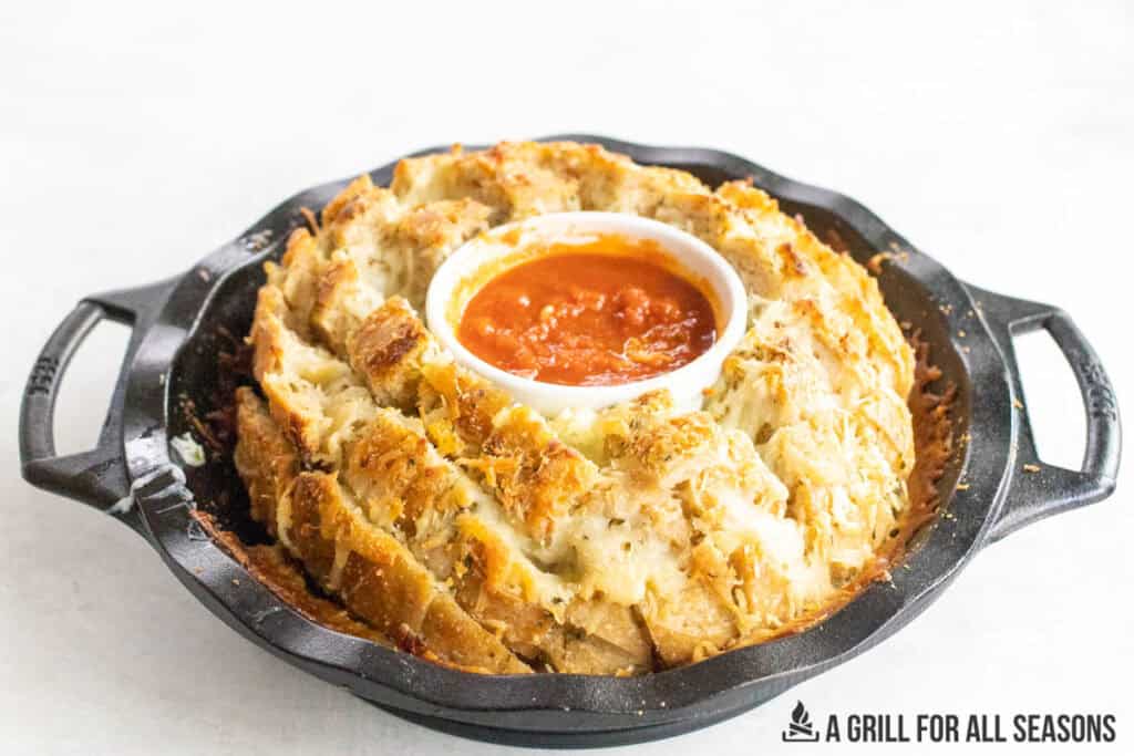 ramekin of marinara set in the middle of the boule