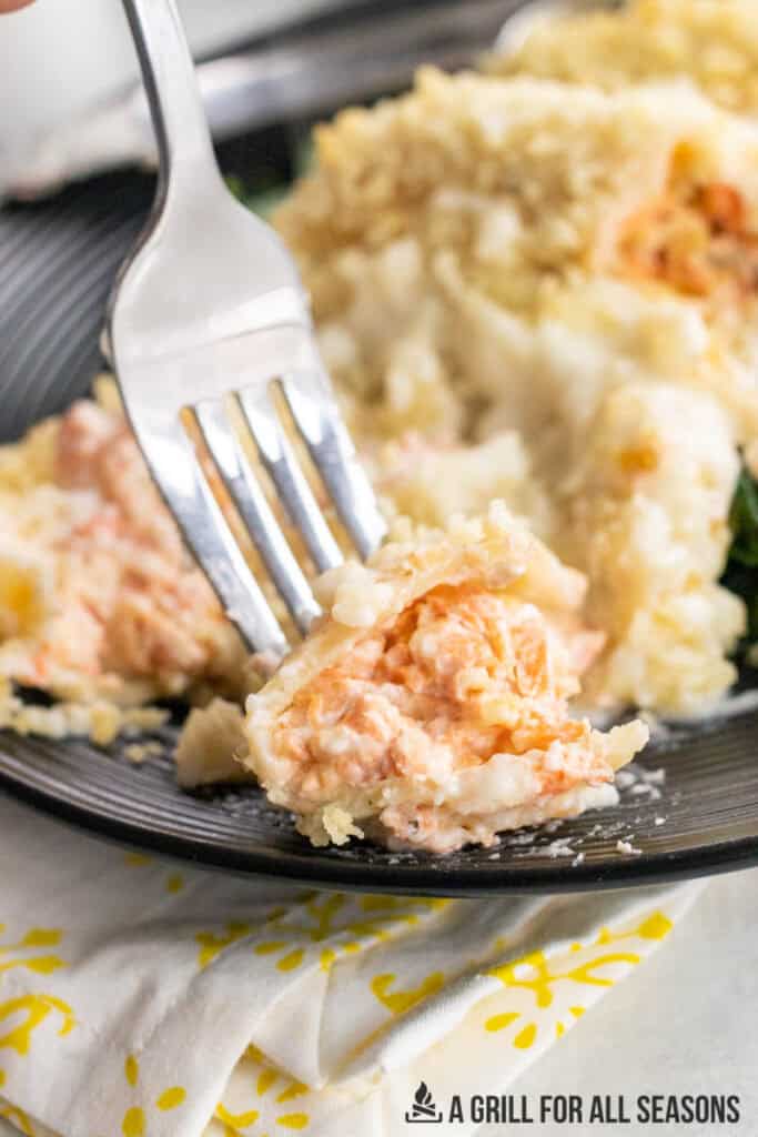 bite of salmon stuffed shell on a fork