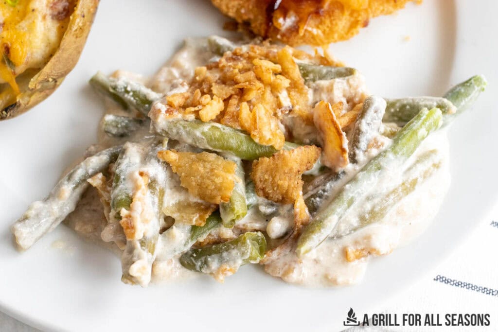 smoked green bean casserole on dinner plate close up