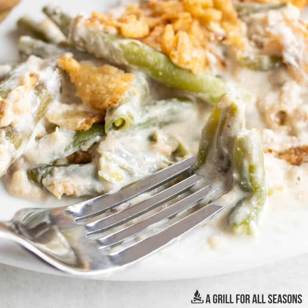 fork with a bite of smoked green bean casserole