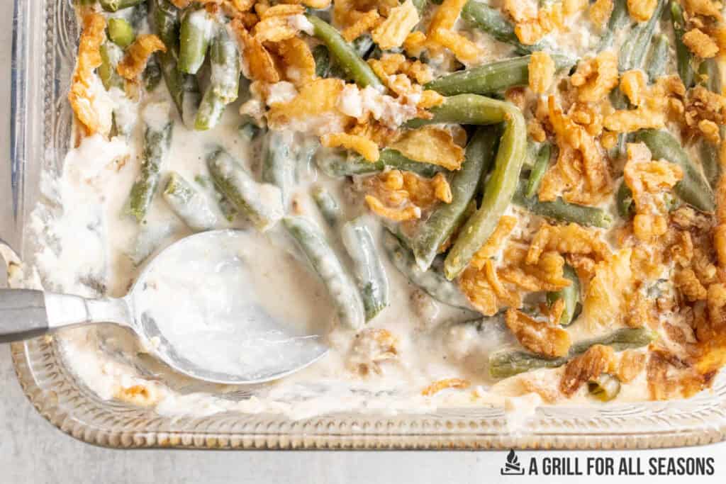 spoon in the smoked green bean casserole in baking dish