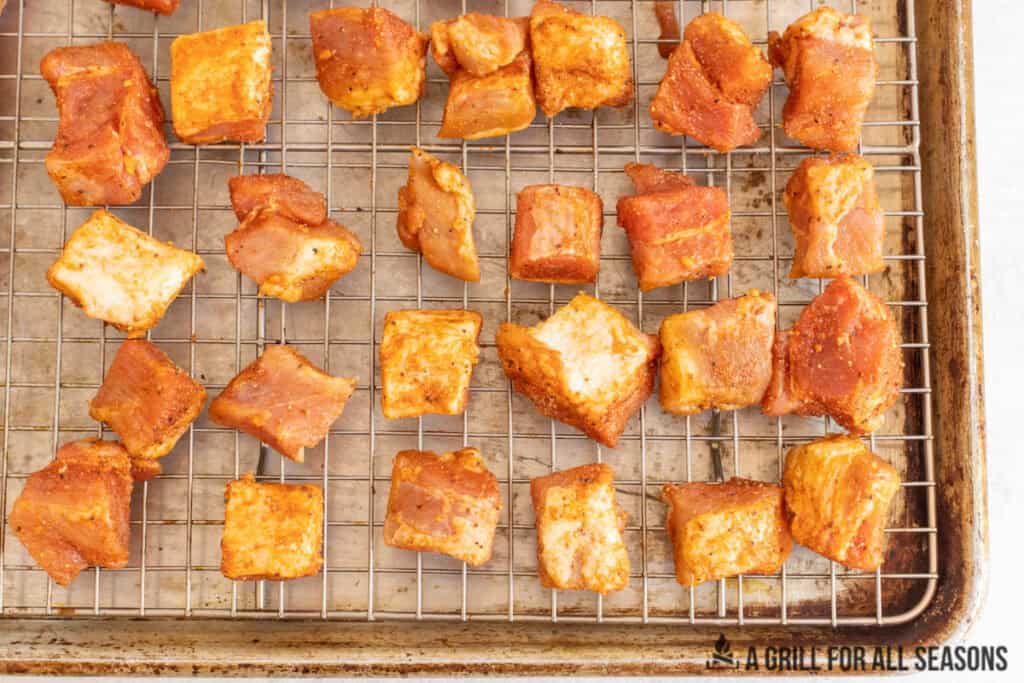 pieces of meat on wire rack