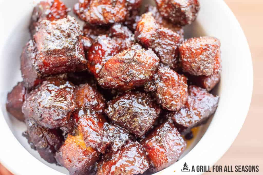 candied pork belly in a bowl with wood background
