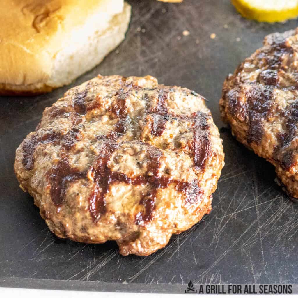 cowboy butter burgers resting on a cutting board