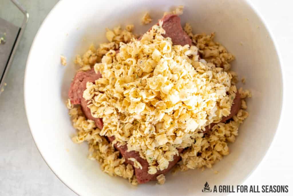 frozen cowboy butter grated on top of ground beef in a bowl