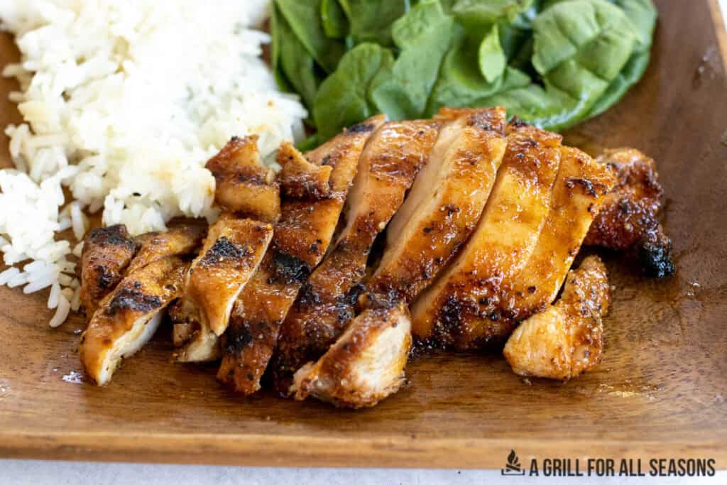 sliced hot honey chicken on wooden plate