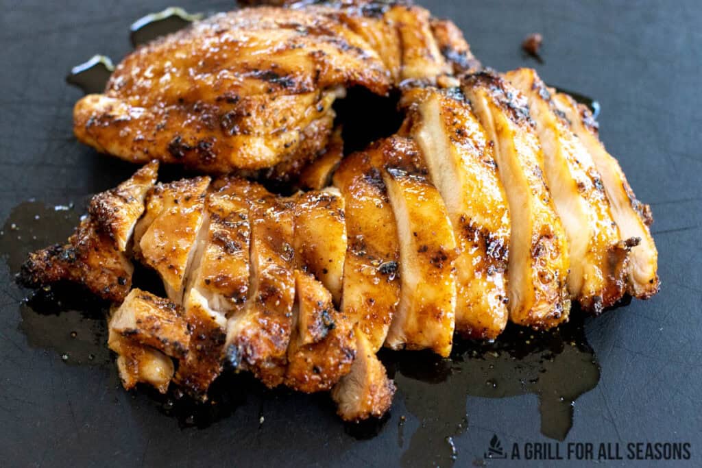 hot honey grilled chicken recipe sliced on black cutting board