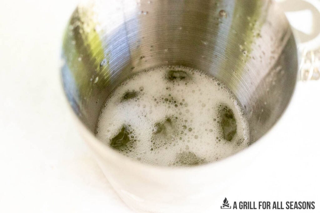 frothy drink in stainless steel cup