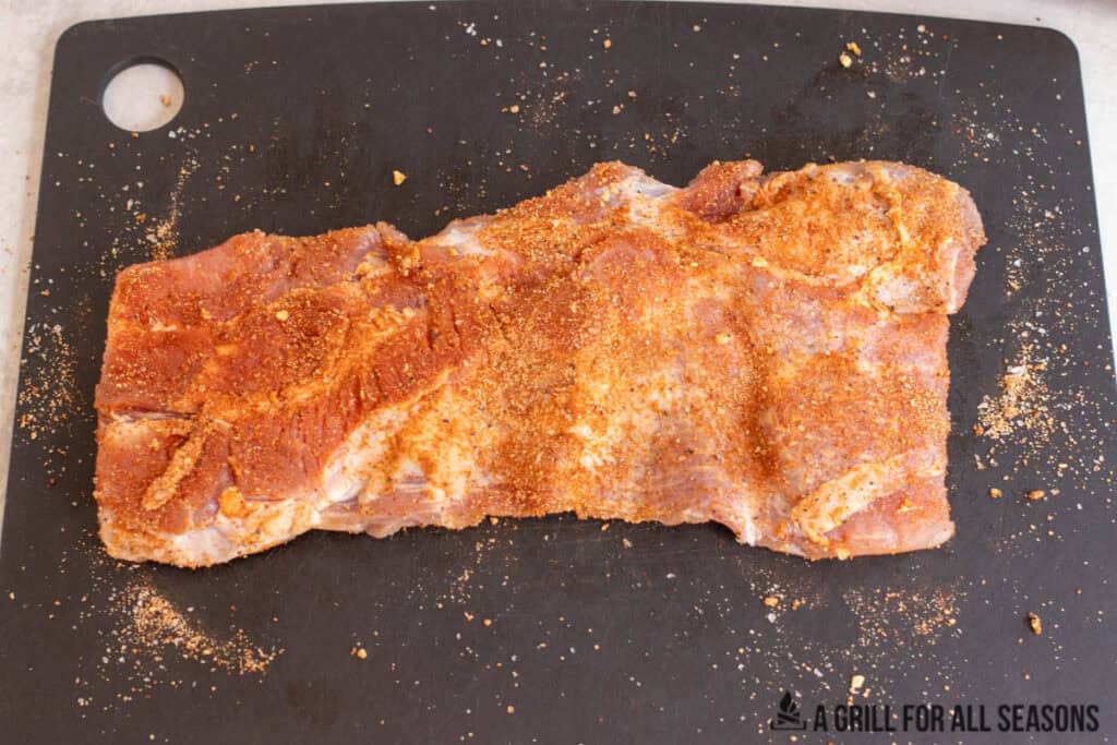 meat with rub on cutting board