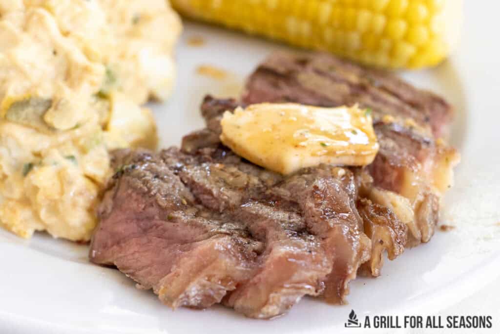 close up of cowboy butter on sliced steak