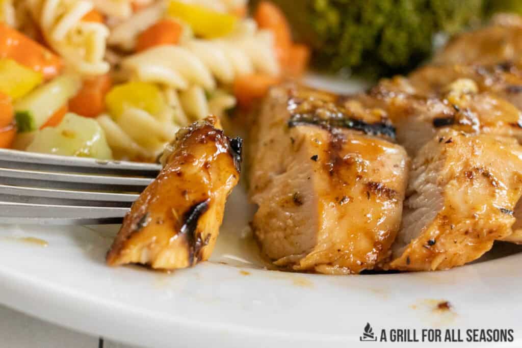 bite of honey mustard grilled chicken breast on a fork