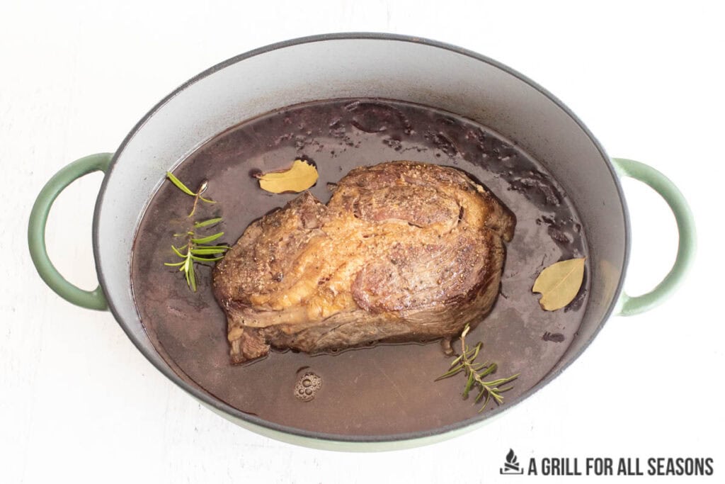 chuck roast back in pot with liquid