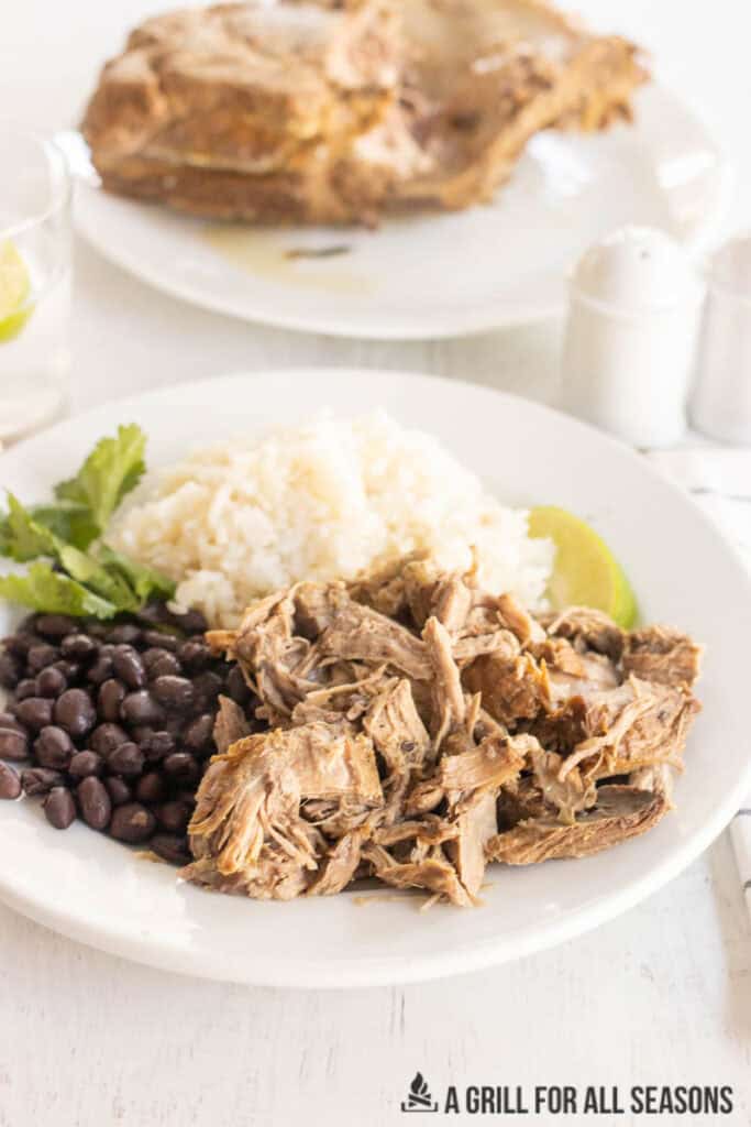 braised pork butt on a plate with rice and beans
