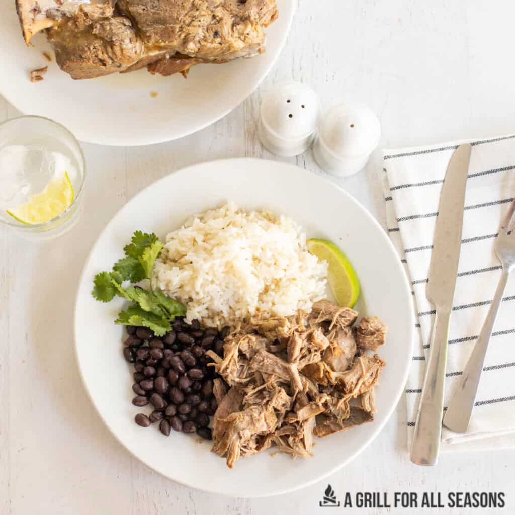 braised pork butt on a plate with rice and beans from overhead