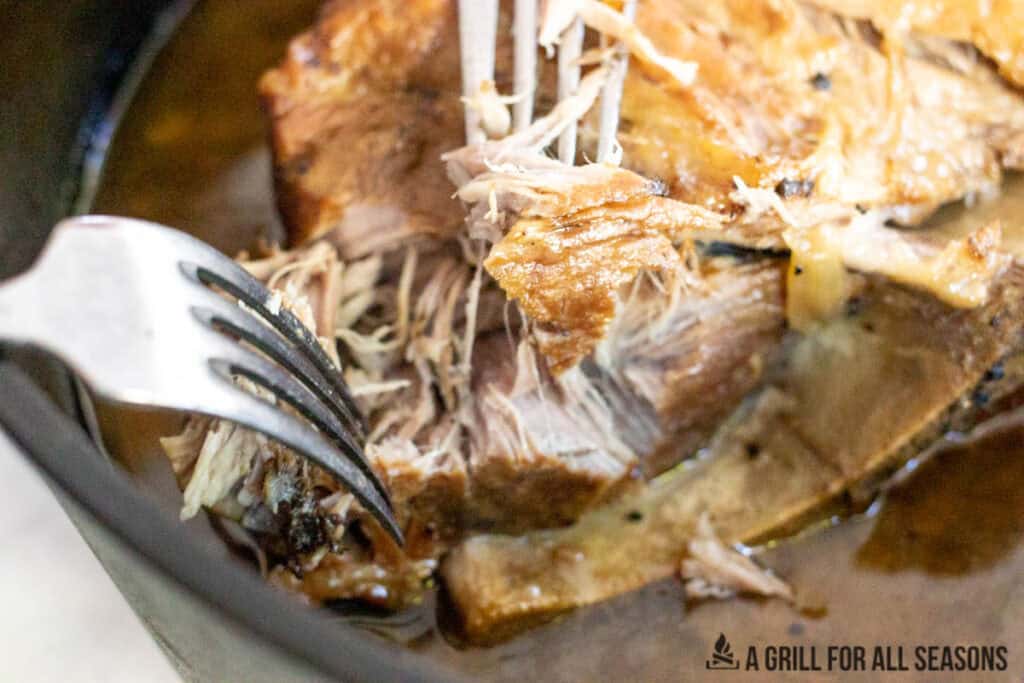 two forks shredding pork