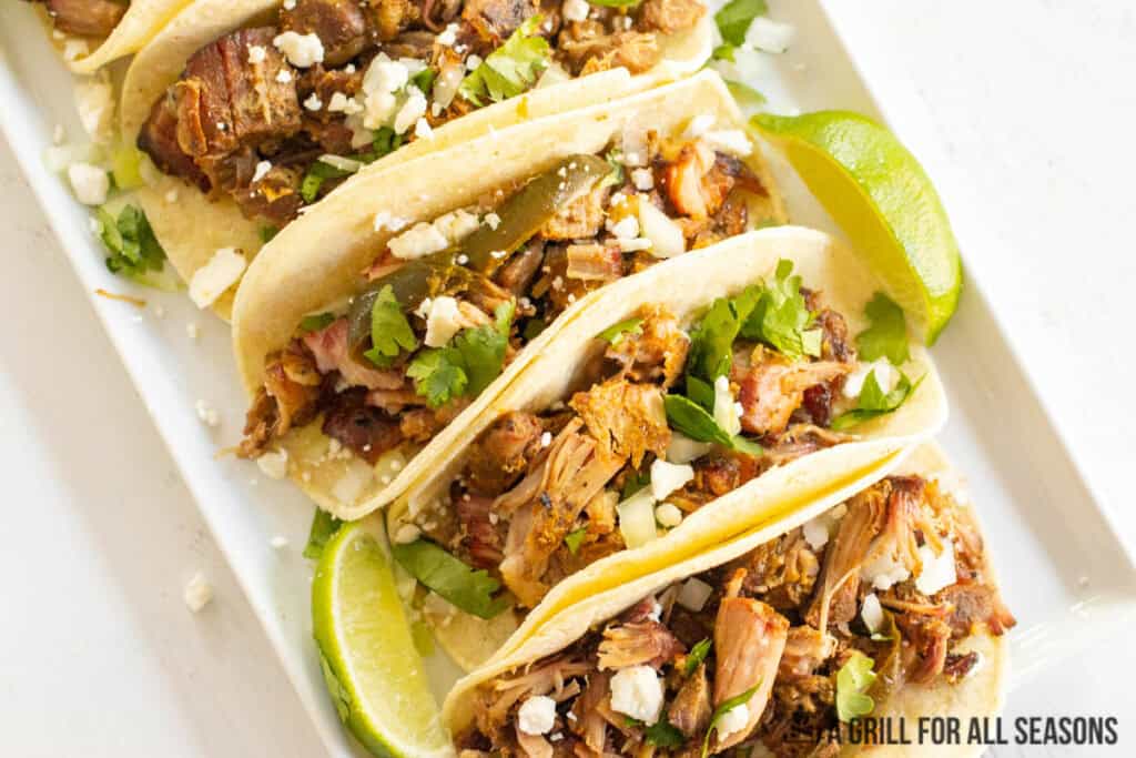 smoked carnitas tacos on white platter