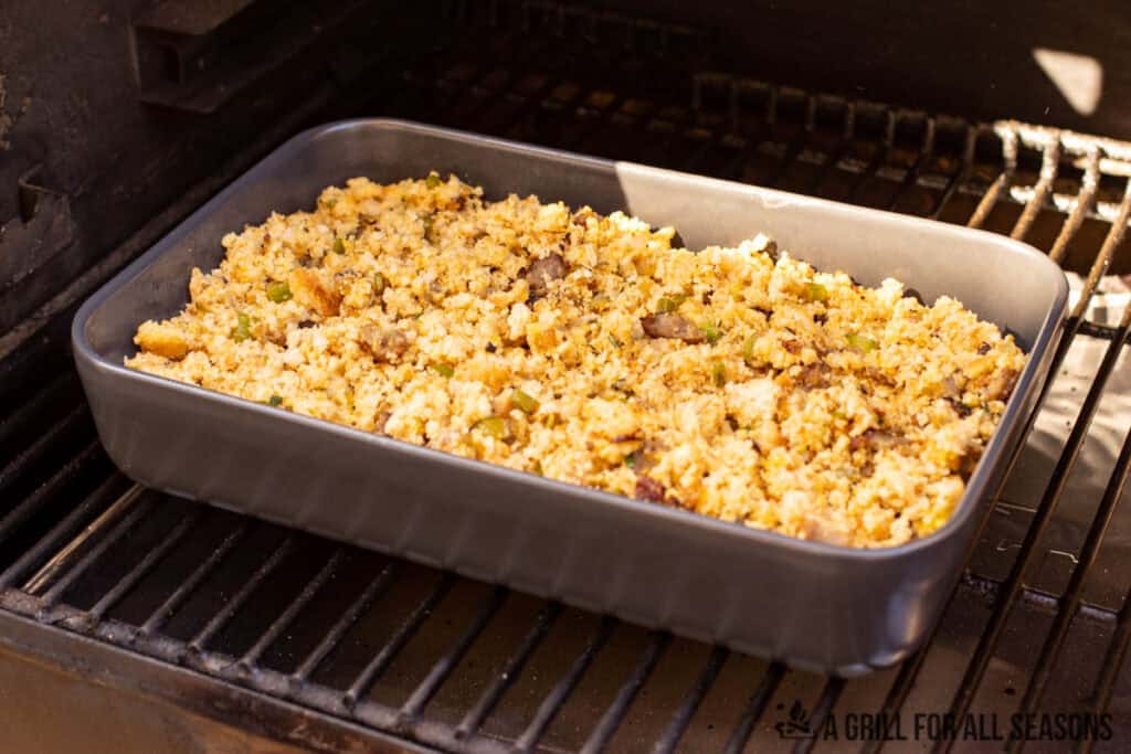 baking dish with stuffing on smoker